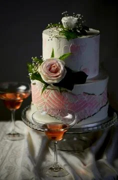 Festive wedding bunk cake decorated with fresh flowers on a dark background Stock Photos