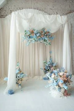 Festive wedding ceremony arrangement featuring soft white curtains, blue flow Stock Photos
