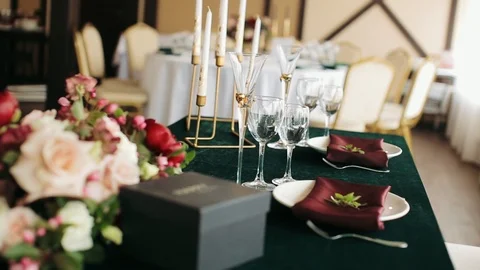 Festive wedding table setting with flowers, napkins, glasses and candlestick. Stock Footage 100522669