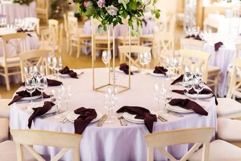 Festive wedding table setting with flowers, napkins, cutlery, glasses, bright Stock Photos