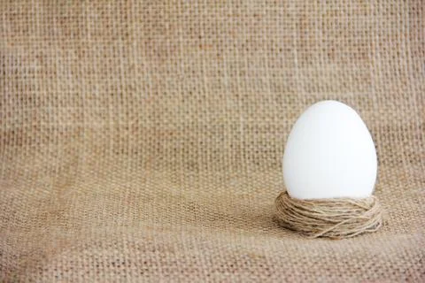 Festive white easter egg on a baggy fabric Stock Photos