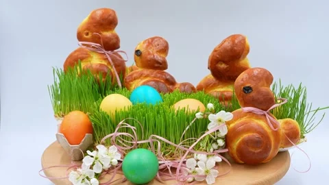 Festively decorated home baked Easter bunnies rotate on a white background Stock Footage 169571663