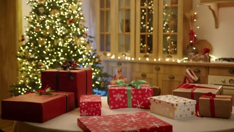 Festively decorated kitchen, Christmas tree with garlands, gift-wrapped boxes Stock Footage 256571137
