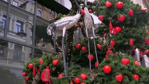 A festively decorated tree with cranes and red heart-shaped ornaments Stock Footage 300901167