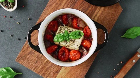 Feta cheese, Onions, cherry Tomatoes and Basil Baked in olive oil. Top view Video stock 240944879