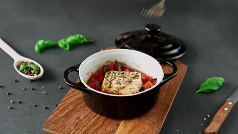 Feta cheese, Onions, cherry Tomatoes and Basil Baked in olive oil with spices Stock Footage 240944896