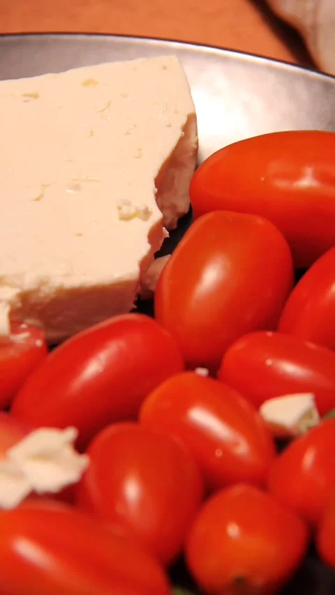 Feta cheese tomato bread platter vertical panning right left close up Stock Footage 321760140