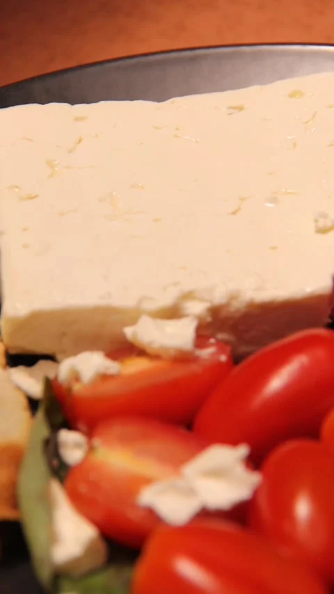Feta cheese tomato bread platter vertical panning left  right close up Stock Footage 321760143