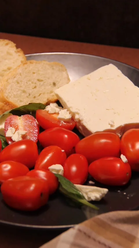 Feta cheese tomato bread platter vertical panning close up Stock Footage 321760210