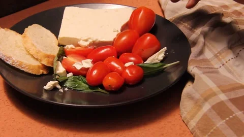Feta cheese tomato bread platter horizontal hand picking food Stock Footage 321760360