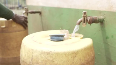Fetching water from tap in slow motion. Stock Footage 320346407