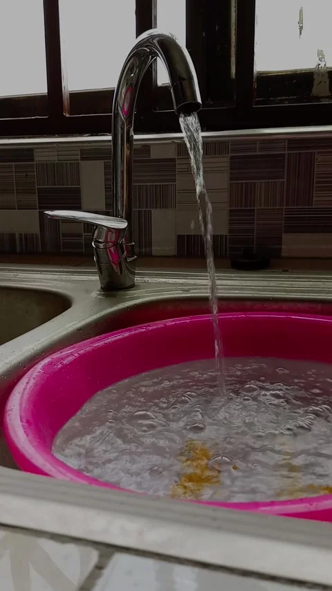 Fetching water from tap into transparent bowl in kitchen sink. Stock Footage 311218641