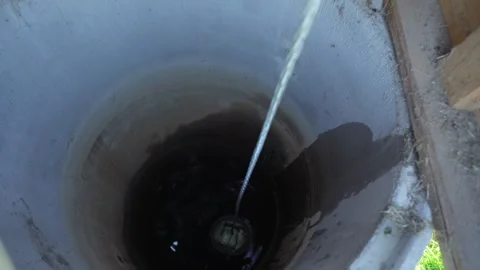 Fetching water from well by hand, fresh pure drinking mineral water. Video stock 283133357