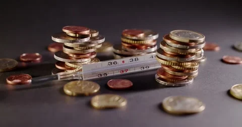 Fever Thermometer between Piled up Euro Coins. Stock Footage 147936450