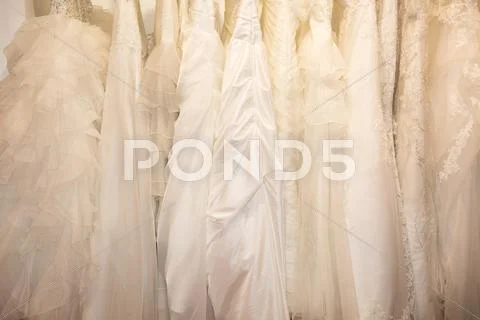 Few beautiful wedding dresses on a hanger Stock Photos
