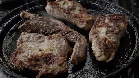 Few beefs being cooked on iron Stock Footage 141864853