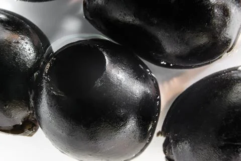 A few black olives close-up. Ingredient for pizza. Stock Photos