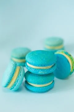 Few of a blue colored macaroons on a flat blue background Stock Photos