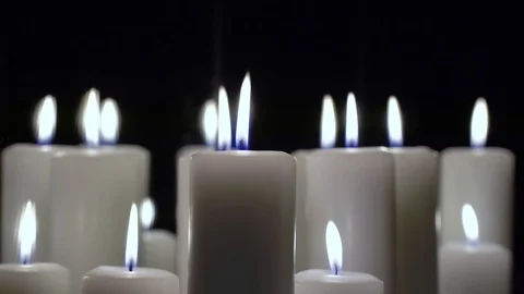 A few candles are burning on a black background. Stock-Footage 102944353