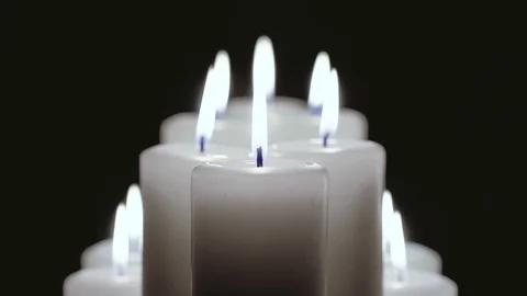 A few candles are burning on a black background. Video stock 102945009
