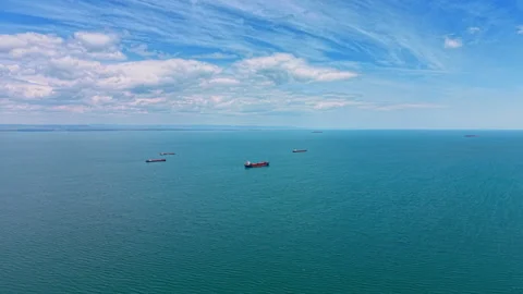 Few cargo ships on the vast turquoise waterscape. Vessels on the roadstead Stock Footage 336267598