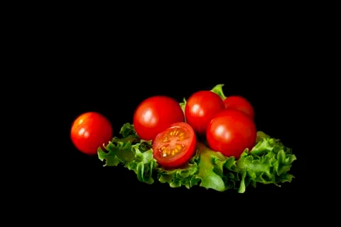 A few cherry tomatoes on a salad leaf Foto stock