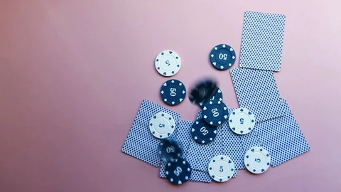 A few chips fall onto the table, where the cards and poker chips lie.  Stock Footage 119927451