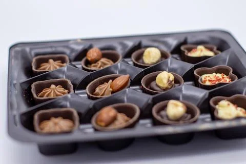Few chocolates in brown box Stock Photos