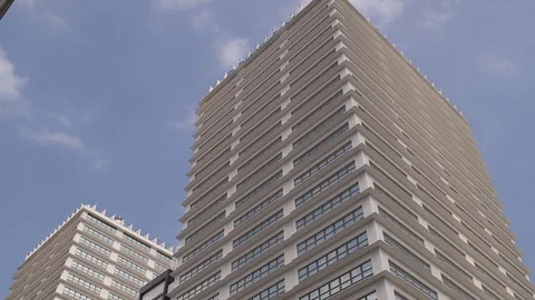 Few clouds moving over office tower 動画素材 76326132