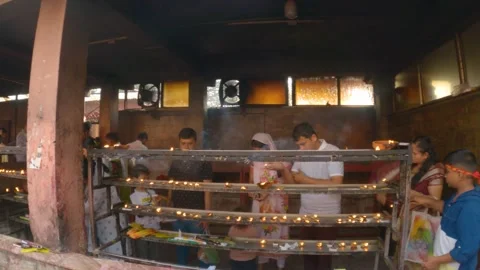 Few devotes offering lamp after puja at Sacred Hindu Shrine in Assam 库存影片 240893538