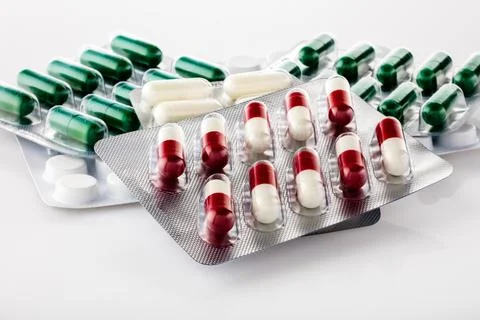 A few different silver sealed blisters with white, green, white-red medicine  Stock Photos