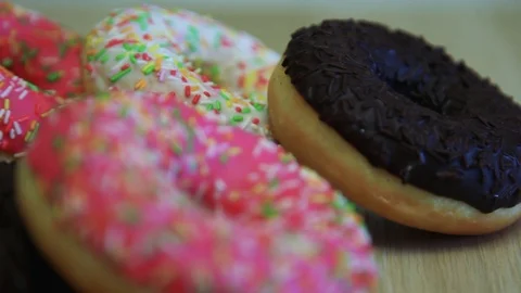 A few donuts lie on the table. Stock Footage 90303486