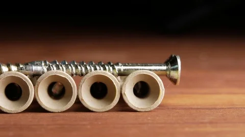 A few dowels lie flat on the carpenter's wooden table. Macro photography moving Stock Footage 73394998