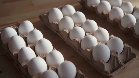 Few eggs in a cardboard box on the table. Stock Footage 106491540