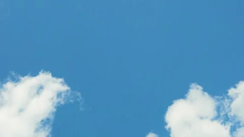 Few Fluffy Cotton White Clouds in Clear Sunny Blue Sky Time Lapse, Good Weather, Video stock 317821054
