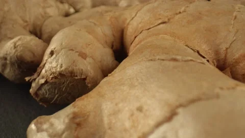 A few ginger roots on the dark surface of the table. Infusion of ginger for the Stock Footage 165191229