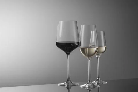 Few glasses of wine on a light background Stock Photos