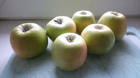 Few green apples on a plastic board Video stock 86790264
