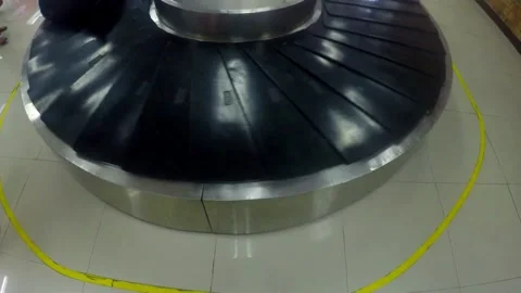 Few large bags move on conveyor belt, luggage claim hall of modern airport, Stock Footage 256748827