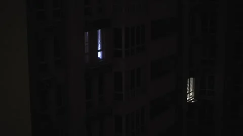 Few Lit Windows in Dark Residential Building During Blackout 스톡 동영상 327331353