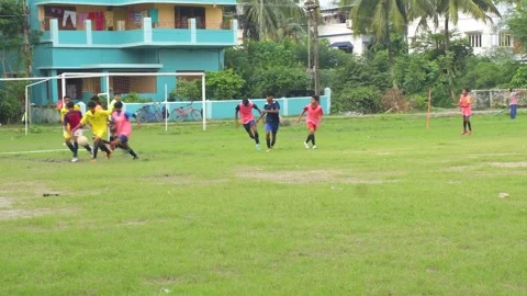 Few local young boys practicing and playing football in front of coach. Stock Footage 249033967