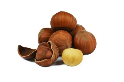 A few nuts of a ripe hazelnut in a shell and a peeled sick kernel of hazelnut Foto stock