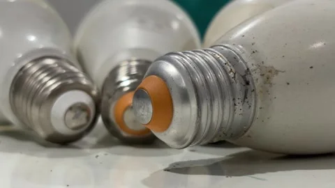 Few old Edison screw light bulb lying on a tabletop. Electricity concept. 스톡 동영상 339321039