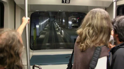 Few passengers stand near front window of automatic train Stockbeeldmateriaal 31204985