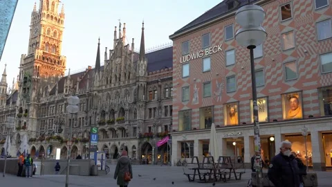 A few people walking on Marienplatz square in the early morning Stock Footage 171069461