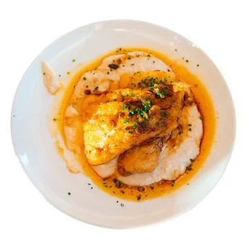 Few pieces of fried cod fillet and side dish of potatoes. Stock Photos
