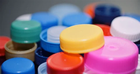 Few Plastic Bottle Caps - Plastic Processing Recycling Industry Stock Footage 128643956