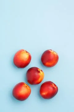 A few ripe nectarines on a blue background Stock Photos