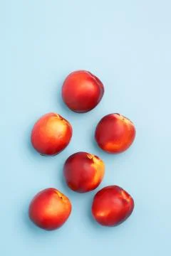 A few ripe nectarines on a blue background Stock Photos