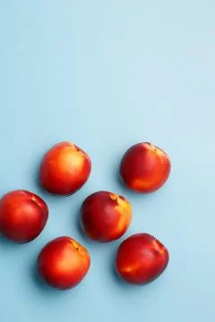 A few ripe nectarines on a blue background Stock Photos